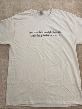 Gildan Cream Short-Sleeve Tee with Black Text "Everyone is born right-handed"